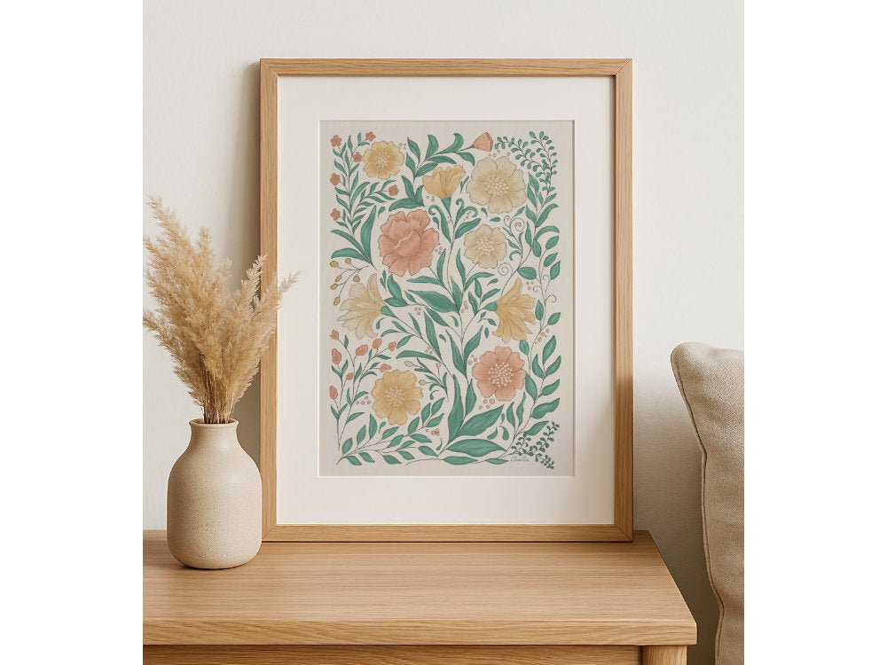 Styled flat lay of floral and botanical gifts for her, including a framed art print, illustrated phone cases, and decorative accessories by Elissa Rua.