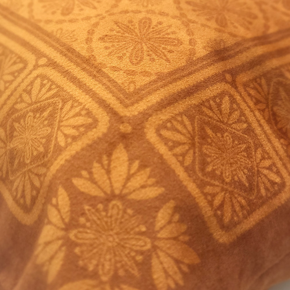 Close-up of copper geometric patterned velvet cushion cover