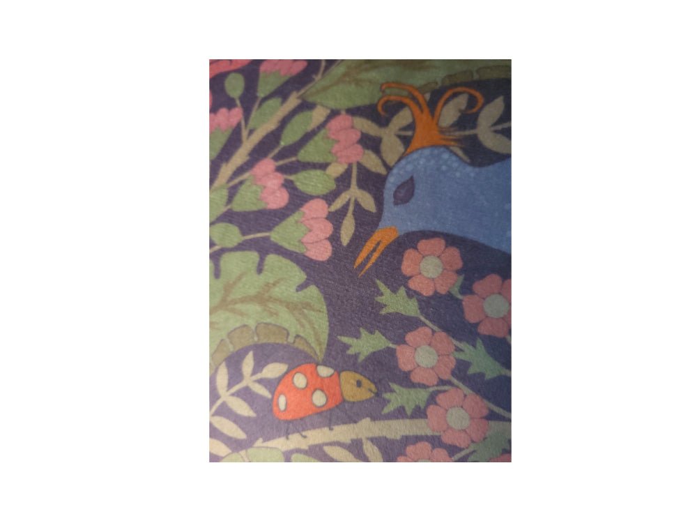 Close-up of peony and birds botanical artwork on luxury velvet cushion cover
