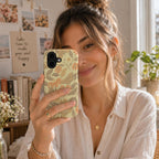 Woman holding a phone case featuring the butterfly and floral design