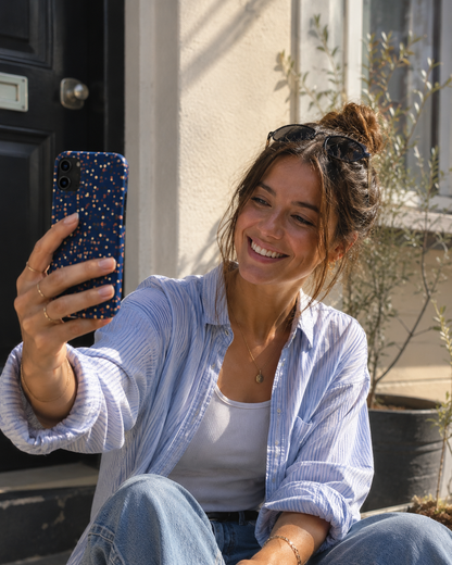 A tough navy phone case in a womans hands