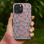 An artist designed pink and blue floral designer phone case being held