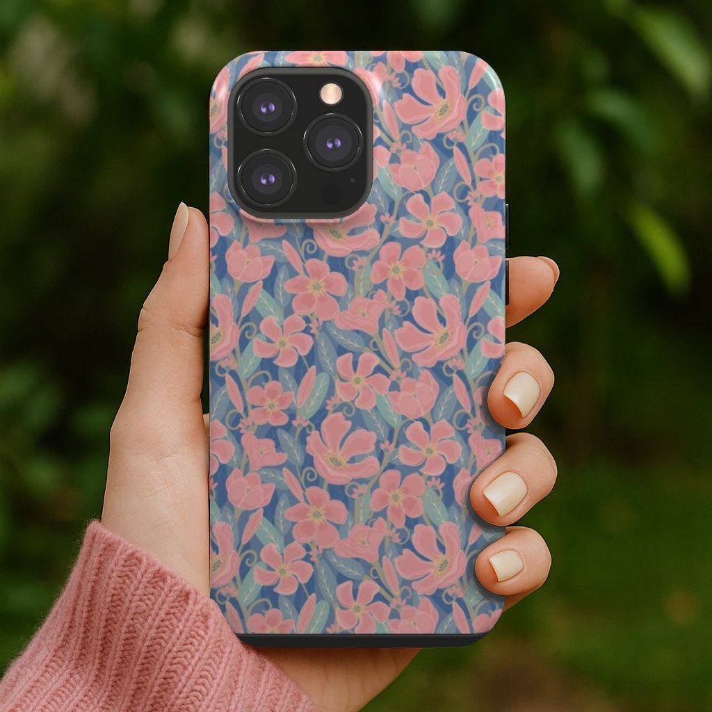 An artist designed pink and blue floral designer phone case being held