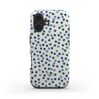 Tough phone case with blue dots on a cream background