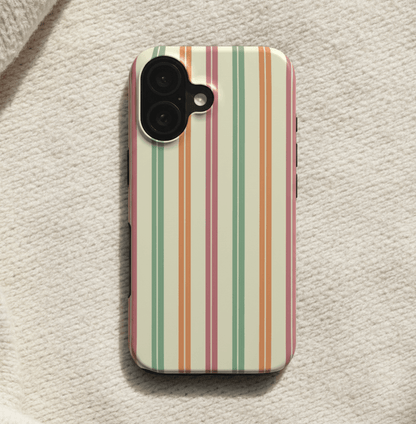 Close-up of striped phone case on cream blanket