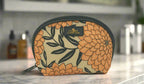 Dahlia cosmetic case with floral pattern by Elissa Rua, displayed on a marble bathroom countertop