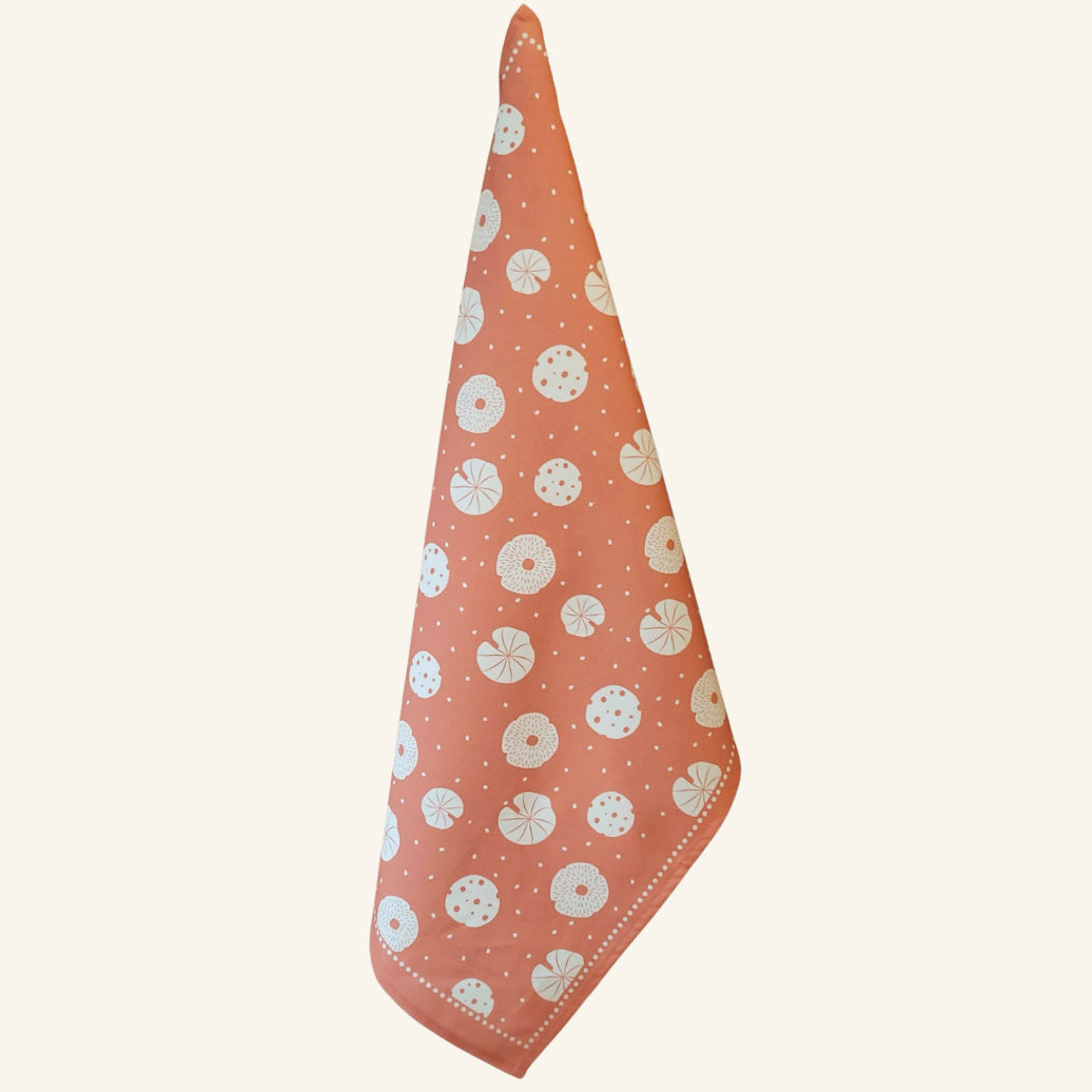 Orange mushroom tea towel shown hanging, nature-inspired designer kitchen towel from the Fabulous Funghi set.