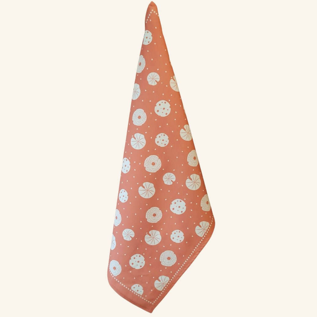 Orange mushroom tea towel shown hanging, nature-inspired designer kitchen towel from the Fabulous Funghi set.