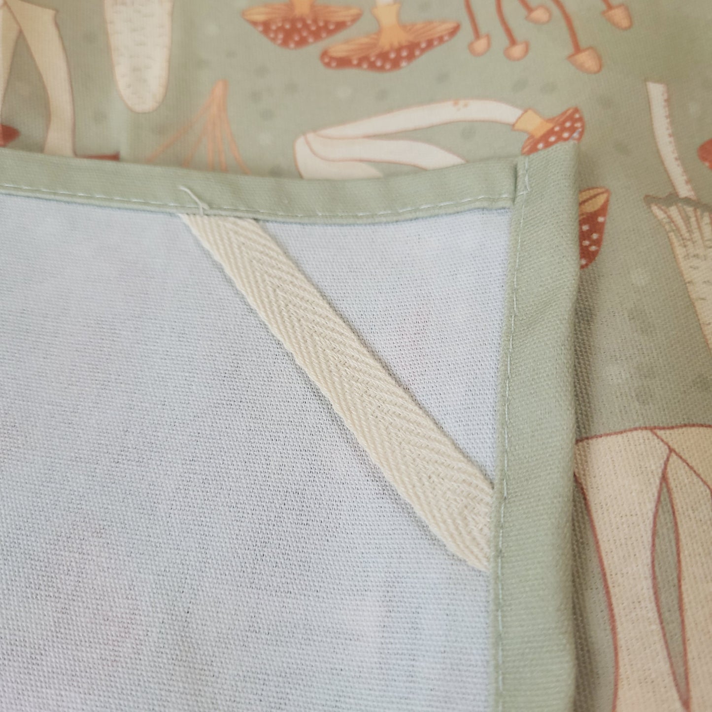 Close-up fabric detail of the Fabulous Funghi mushroom tea towel, showcasing premium botanical print quality.