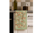 Fabulous Funghi tea towel displayed on a kitchen counter, showcasing the botanical mushroom design in a real home setting.