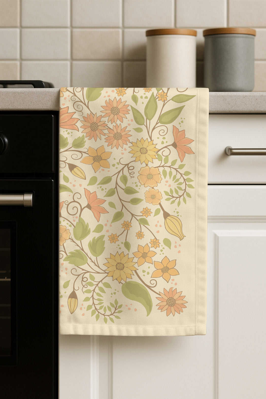 Floral Wilderness tea towel hanging in a kitchen setting, showcasing the botanical floral design in a real home environment.