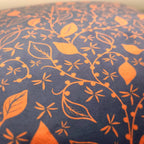 Close-up of navy and copper floral print on luxury velvet cushion cover