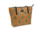 Yellow and black Dahlia tote bag by Elissa Rua — angled view showing artistic floral design and structured shape, women’s designer handbag.