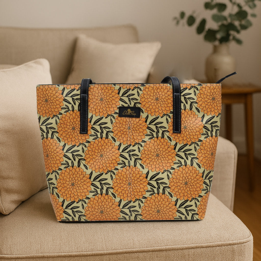 Yellow and black Dahlia tote bag by Elissa Rua placed on a beige chair — artistic designer women’s shoulder handbag, lifestyle photo.